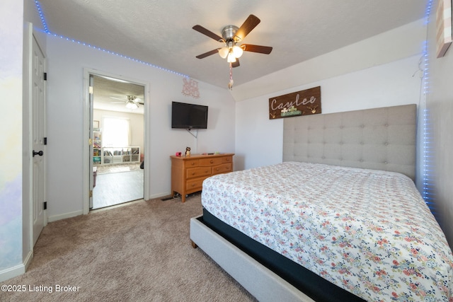 carpeted bedroom featuring ceiling fan, baseboards, and a textured ceiling