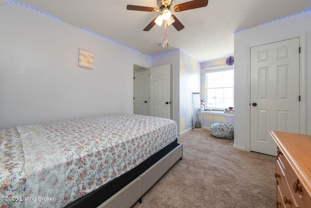 bedroom with light carpet, ceiling fan, and baseboards