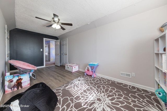 rec room featuring visible vents, a textured ceiling, baseboards, and wood finished floors