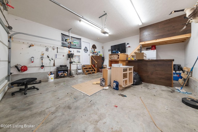 garage featuring a garage door opener and a workshop area