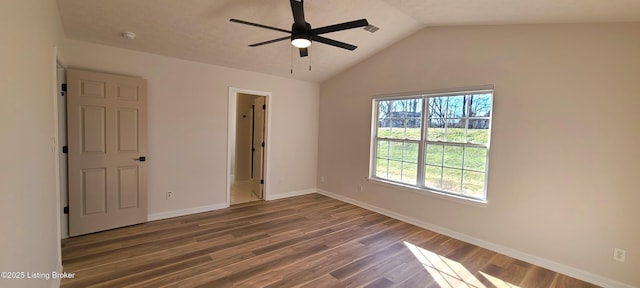 unfurnished bedroom with lofted ceiling, a ceiling fan, baseboards, and wood finished floors