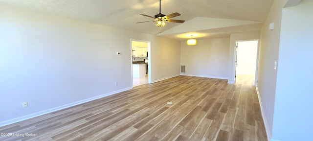 unfurnished room featuring lofted ceiling, a ceiling fan, visible vents, baseboards, and light wood finished floors