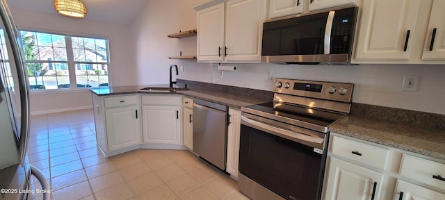 kitchen with stainless steel appliances, white cabinets, a sink, and open shelves