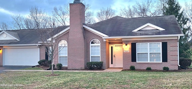 ranch-style house with a front lawn, an attached garage, brick siding, and a chimney