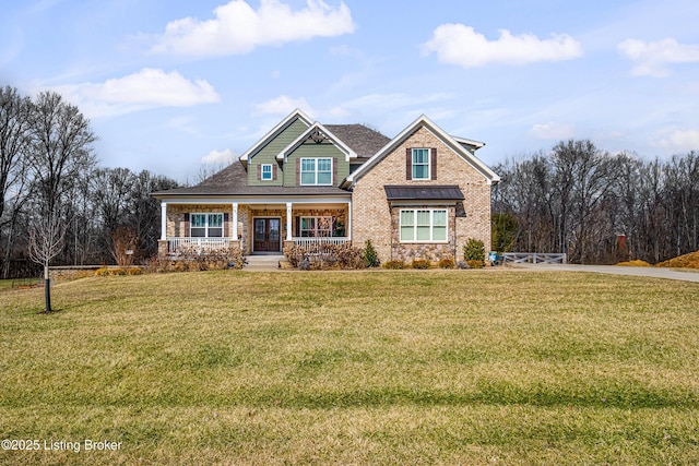 craftsman-style house featuring covered porch, brick siding, and a front yard