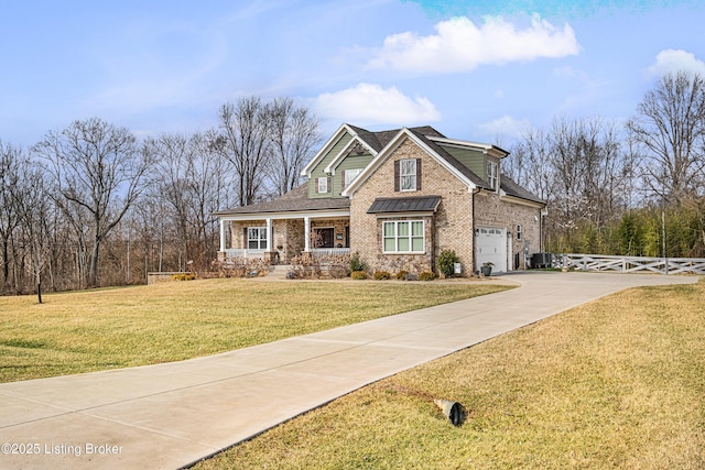 craftsman inspired home featuring brick siding, fence, concrete driveway, and a front yard