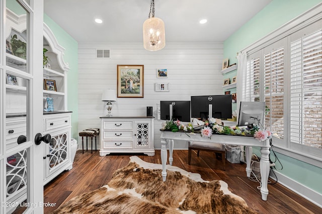 office featuring a wealth of natural light, dark wood-style flooring, and visible vents