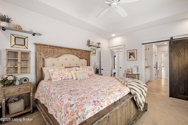 bedroom featuring light carpet, ceiling fan, a barn door, and recessed lighting