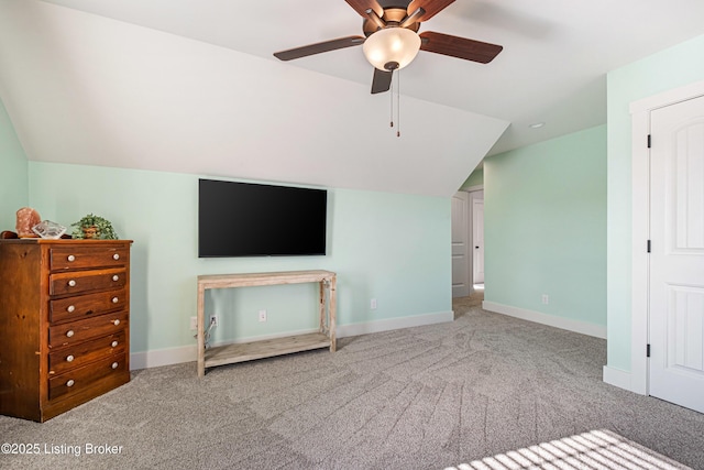 interior space with lofted ceiling, carpet floors, and baseboards