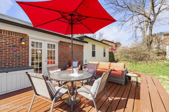 wooden deck featuring outdoor dining space, french doors, and outdoor lounge area