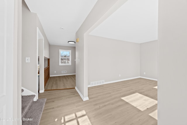 interior space with visible vents, baseboards, and wood finished floors