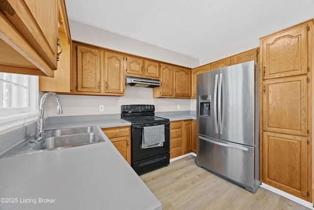 kitchen with stainless steel fridge with ice dispenser, black / electric stove, light countertops, under cabinet range hood, and a sink