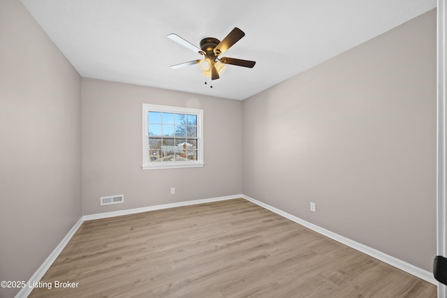 unfurnished room with light wood-style floors, visible vents, baseboards, and a ceiling fan