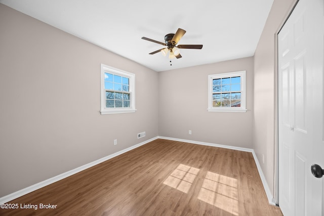 unfurnished bedroom with light wood-type flooring, ceiling fan, and baseboards