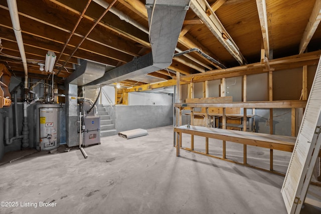 unfinished basement featuring water heater, stairs, and heating unit