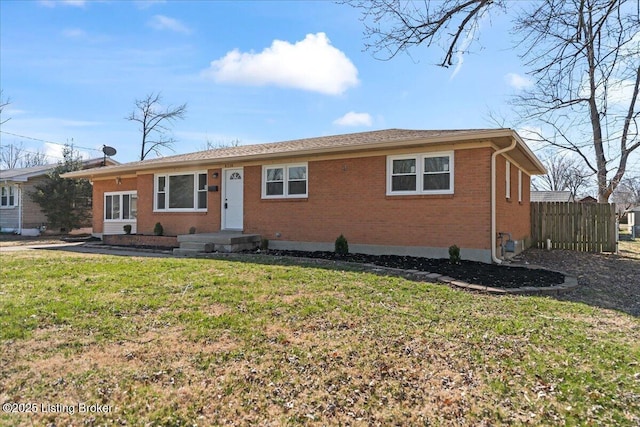 ranch-style house featuring brick siding, a front lawn, and fence