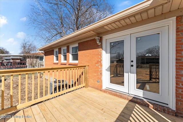 wooden terrace with central AC unit and french doors