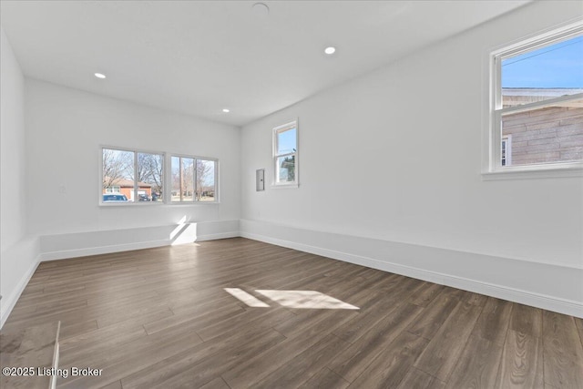 empty room featuring recessed lighting, baseboards, and wood finished floors