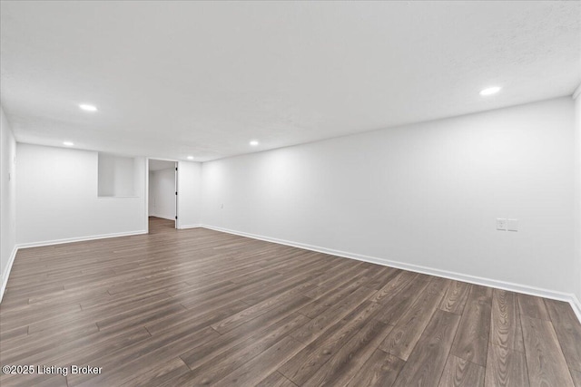 finished basement featuring dark wood finished floors, recessed lighting, and baseboards