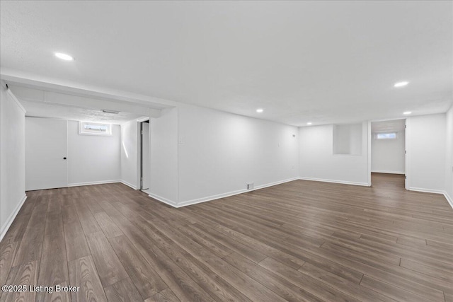 below grade area featuring recessed lighting, baseboards, and wood finished floors