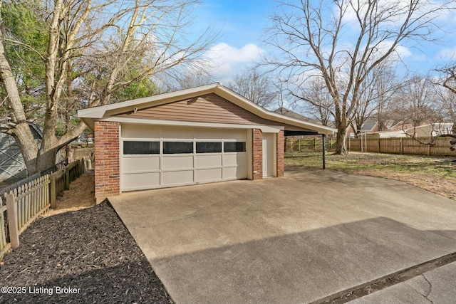 detached garage featuring fence