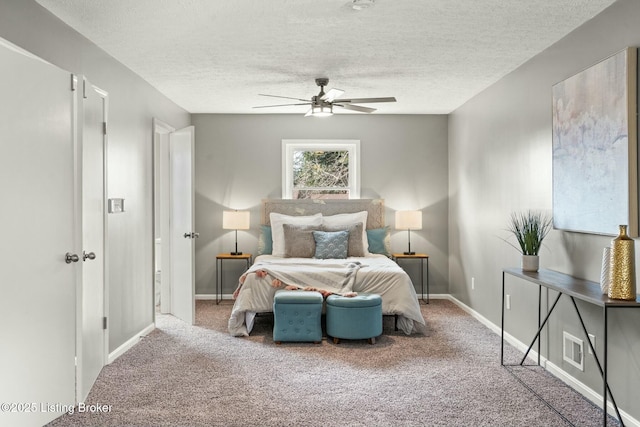 bedroom with a textured ceiling, ceiling fan, carpet flooring, and baseboards