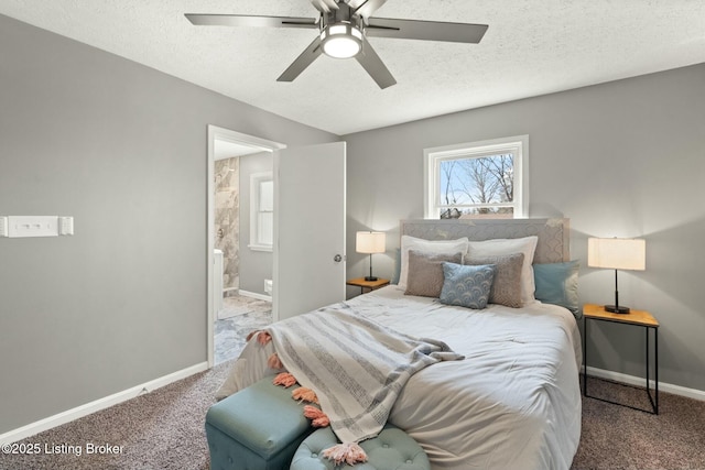 carpeted bedroom featuring a textured ceiling, ensuite bath, a ceiling fan, and baseboards