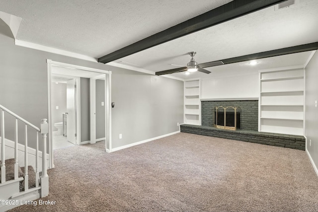 unfurnished living room with carpet, a fireplace, a textured ceiling, beamed ceiling, and baseboards