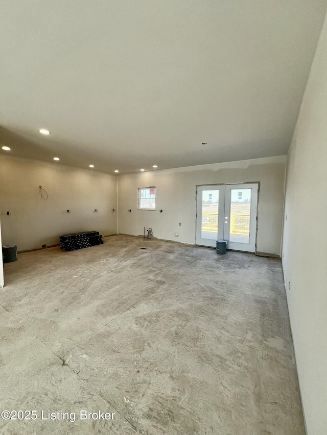 unfurnished living room with french doors and recessed lighting