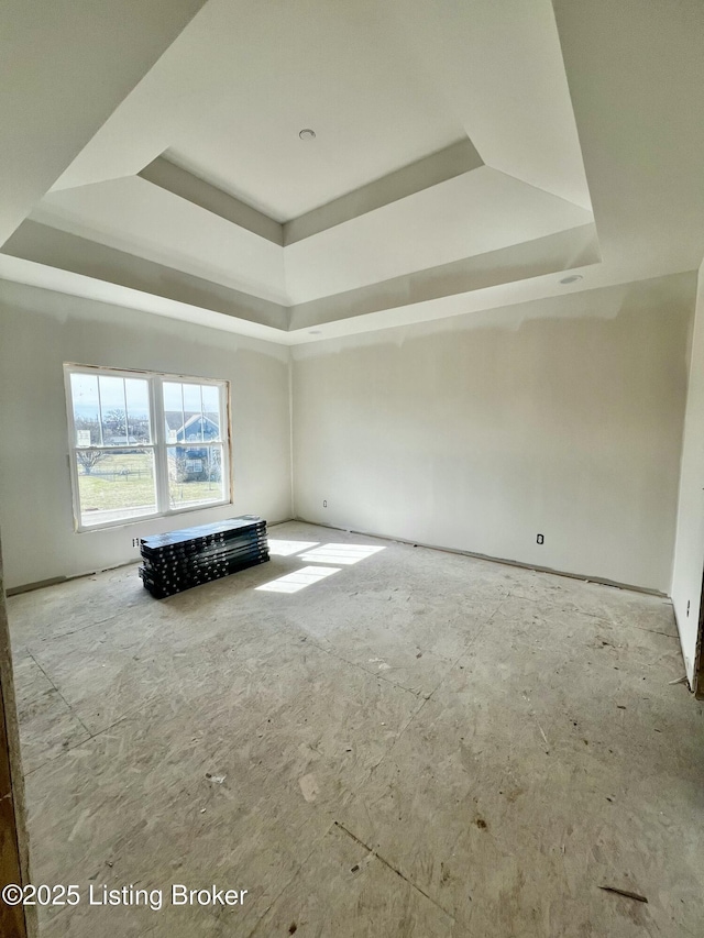 unfurnished room featuring a tray ceiling