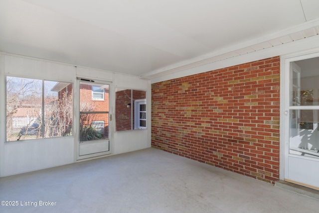 empty room featuring concrete flooring and brick wall