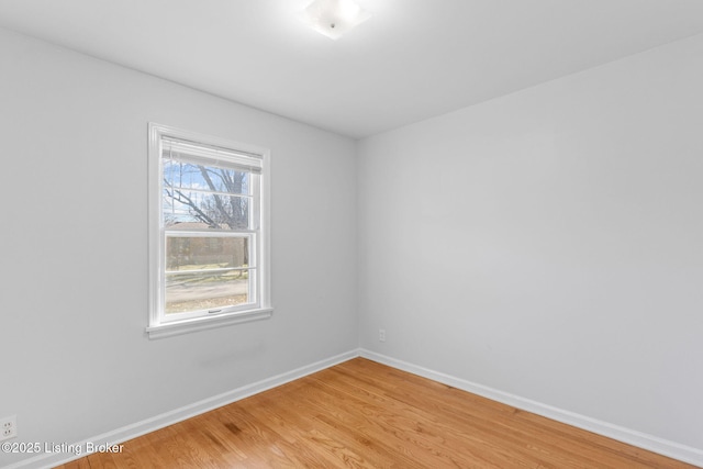 empty room with light wood-type flooring and baseboards