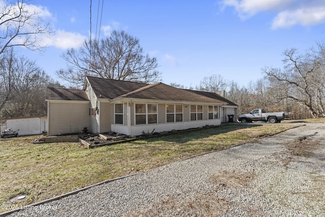 view of home's exterior with a yard and driveway