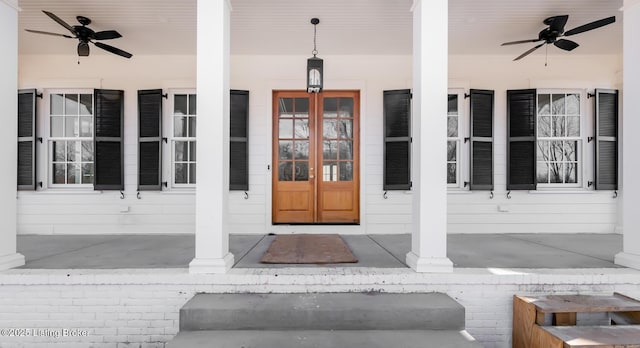 entrance to property featuring covered porch, french doors, and a ceiling fan