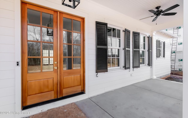 property entrance with a porch, a ceiling fan, and french doors