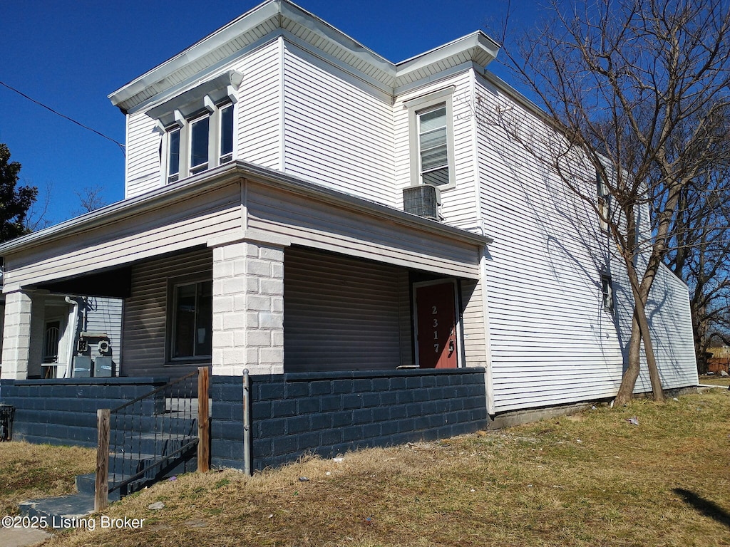 view of side of home with a porch