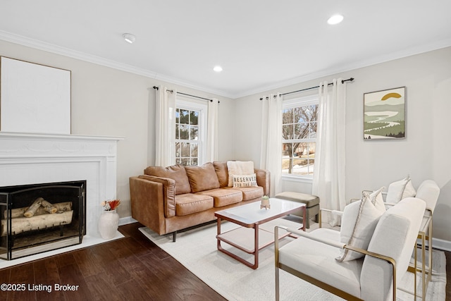 living area with a fireplace with flush hearth, ornamental molding, dark wood finished floors, and recessed lighting