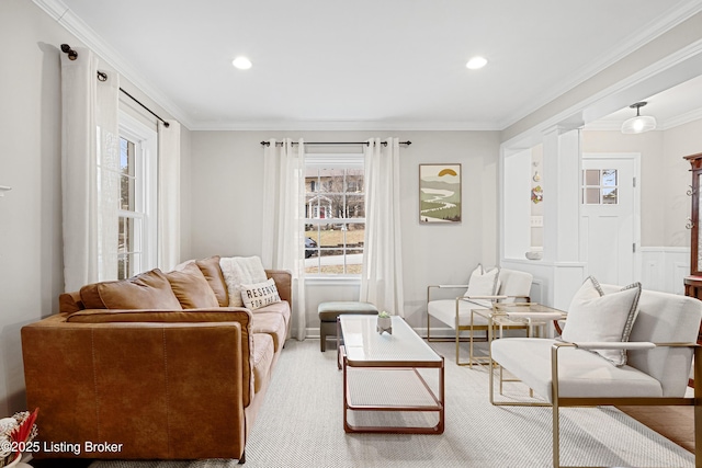 living room with ornamental molding and recessed lighting