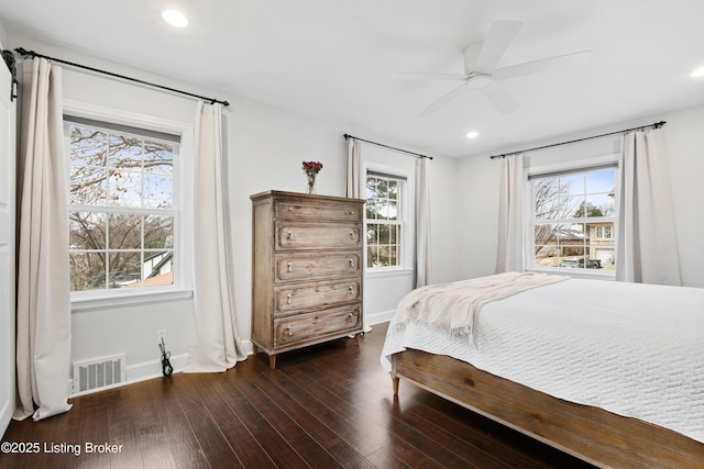 bedroom featuring ceiling fan, recessed lighting, visible vents, baseboards, and dark wood-style floors