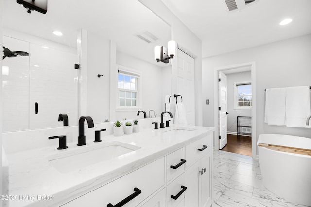 full bath with marble finish floor, a stall shower, a sink, and visible vents