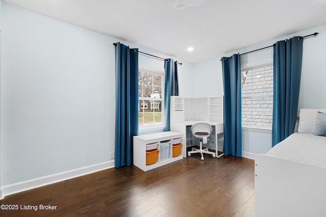 bedroom featuring dark wood-type flooring, multiple windows, and baseboards