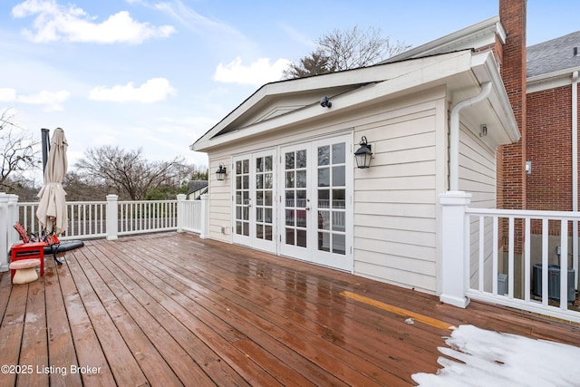 wooden deck featuring central air condition unit