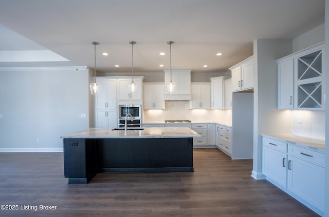 kitchen featuring dark wood-type flooring, a sink, white cabinetry, and tasteful backsplash