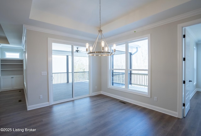 unfurnished dining area with dark wood-style floors, visible vents, ornamental molding, and baseboards