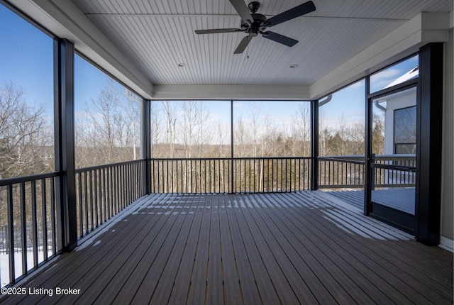 unfurnished sunroom with a ceiling fan