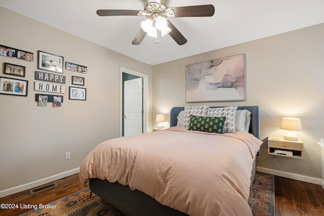 bedroom featuring visible vents, ceiling fan, baseboards, and wood finished floors