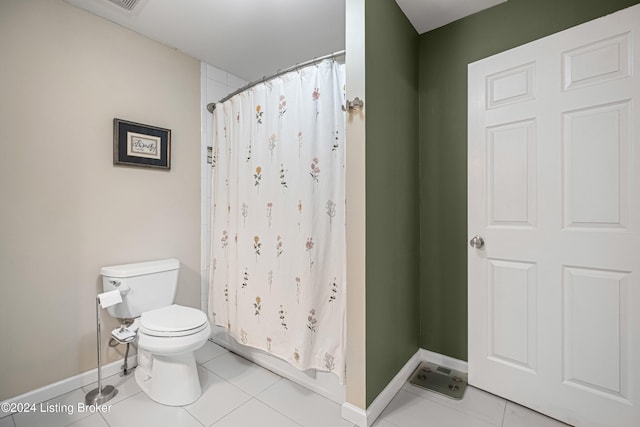 bathroom featuring curtained shower, baseboards, toilet, and tile patterned floors