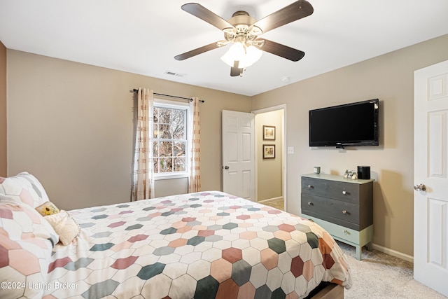 bedroom featuring light carpet, ceiling fan, visible vents, and baseboards