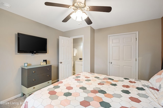 carpeted bedroom with ceiling fan, baseboards, and ensuite bathroom