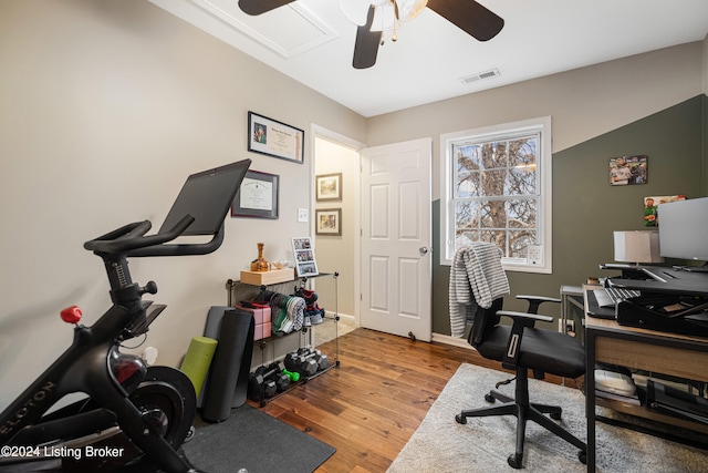 office with a ceiling fan, visible vents, and wood finished floors